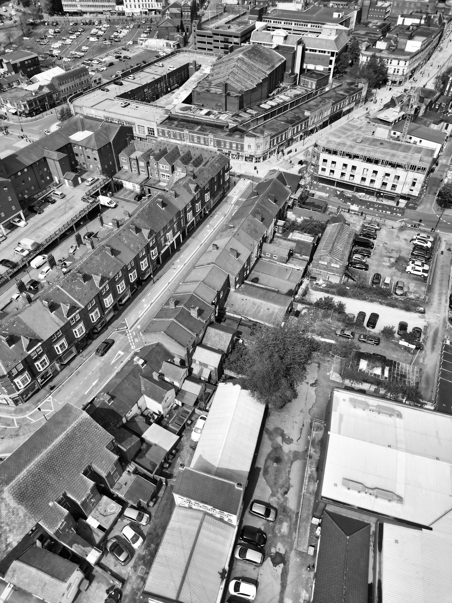Black and white aerial shot of West Midlands showcasing urban buildings and streets.